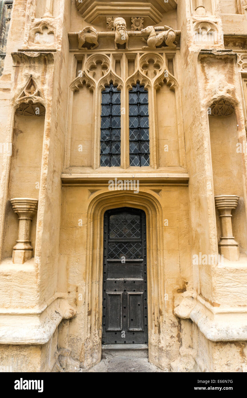 Ornate wooden door, windows, gargoyles from the south porch of the Church of St John Baptist, Cirencester, Cotswolds, Gloucestershire, England, UK. Stock Photo