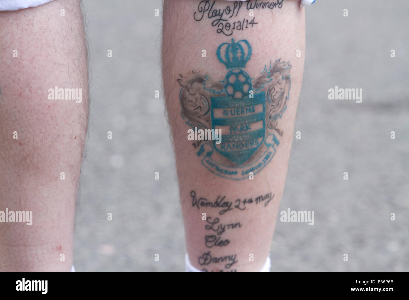 London,UK. 16th August 2014. A supporter with the Queens Park Rangers club crest tattooed on his leg. Football supporters arrive on the opening day of the English football league season fixture between Queens Park Rangers FC and Hull FC at Loftus Road London Credit:  amer ghazzal/Alamy Live News Stock Photo