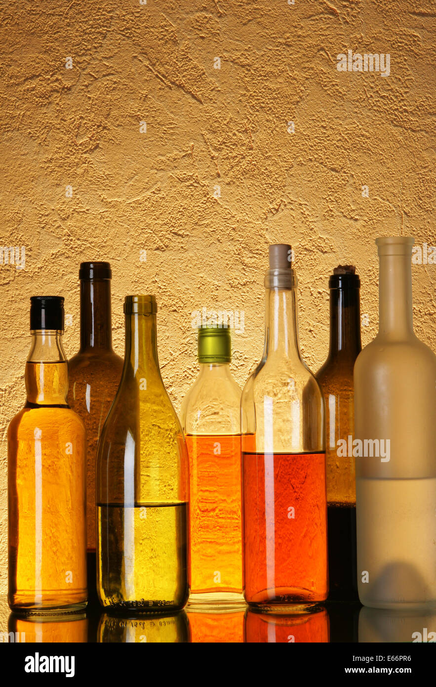 Lots bottles of alcoholic beverages over textured background Stock ...