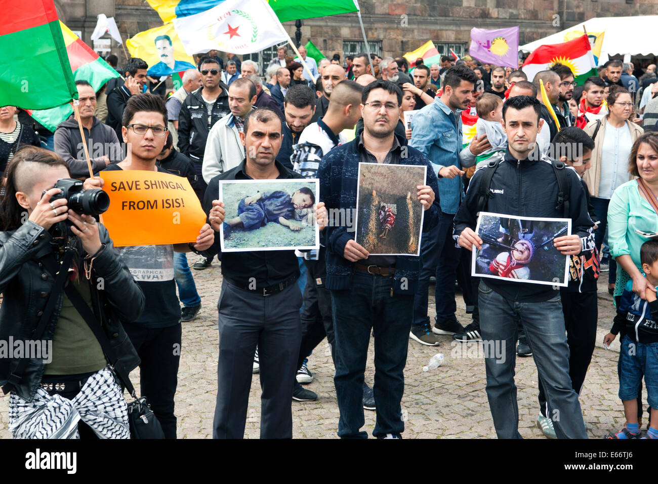 Copenhagen, Denmark – August 16th, 2014: Kurds demonstrates in front of the Danish parliament in Copenhagen against ISIS (Islamic State) warfare and atrocities in Iraq.  On the photo protestors displays photo of murdered children, a war crime allegedly carried out by ISIS in Iraq. Credit:  OJPHOTOS/Alamy Live News Stock Photo