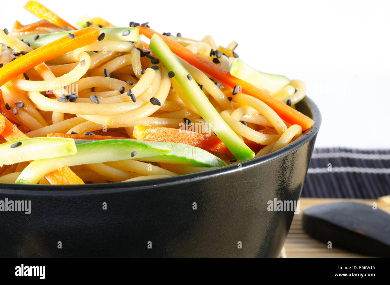 Serving of spaghetti with carrots and zucchini and soy sauce and sesame