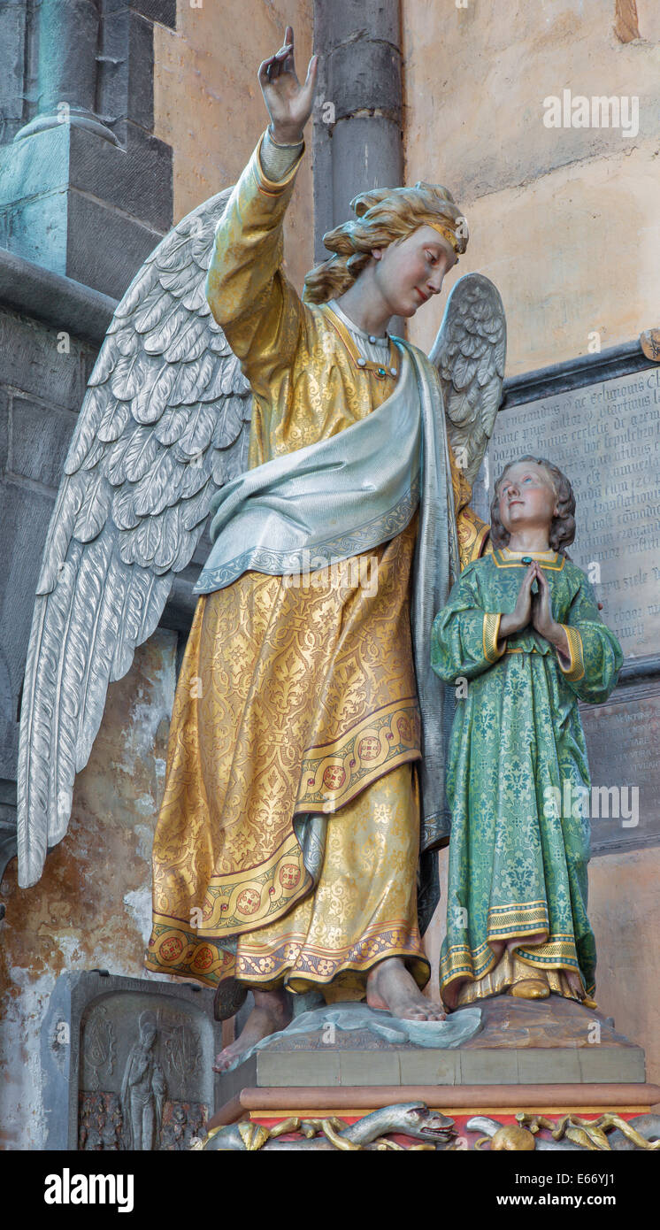 BRUGES, BELGIUM - JUNE 12, 2014: The Guardian angel statue in the church Our Lady. Stock Photo