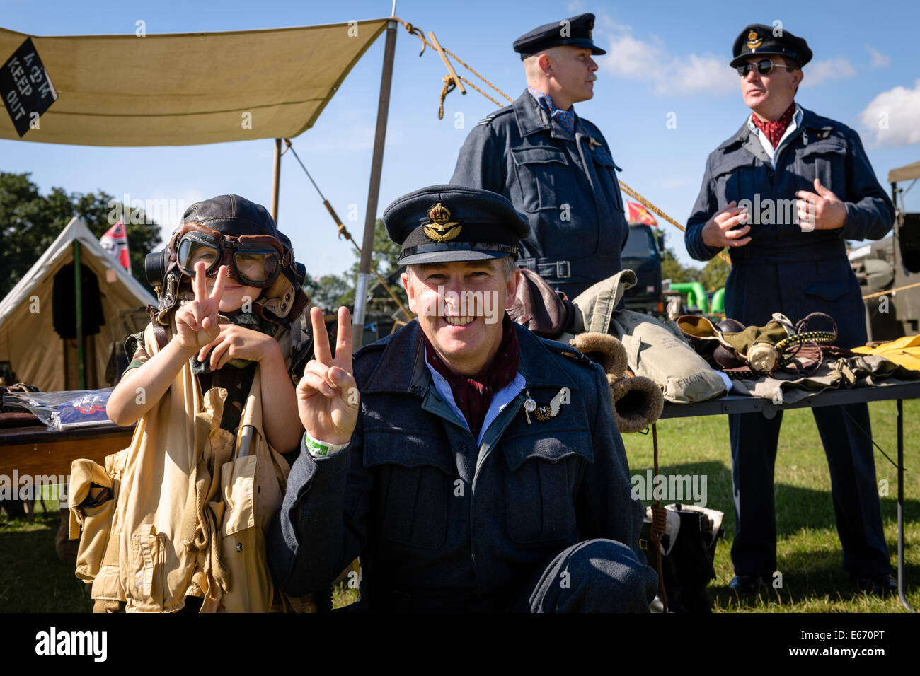 Kent, UK. 16th Aug, 2014. Men in RAF uniforms posing for photos to collect for charity at The 6th Annual Combined Ops Show at Headcorn Airfield. Featuring fly-overs, war re-enactments, fancy dress, actual and replica memorabilia, and more. Credit:  Tom Arne Hanslien/Alamy Live News Stock Photo