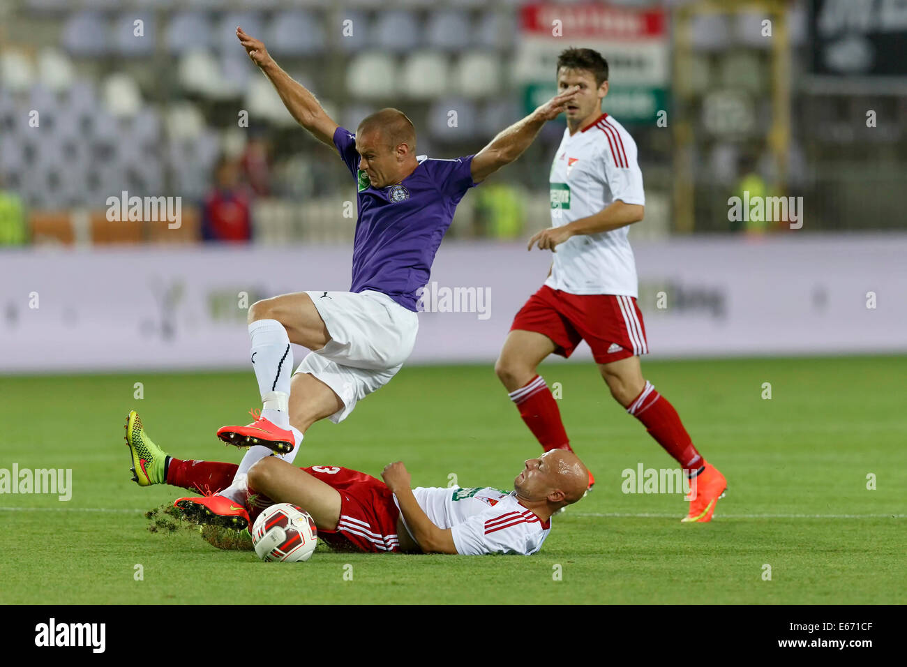 BUDAPEST, HUNGARY - AUGUST 16, 2014: Filip Stanisavljevic of UTE (l) is tackled by Jozsef Varga of DVSC during UTE vs. DVSC OTP Bank League football match at Szusza Stadium on August 16, 2014 in Budapest, Hungary. Credit:  Laszlo Szirtesi/Alamy Live News Stock Photo