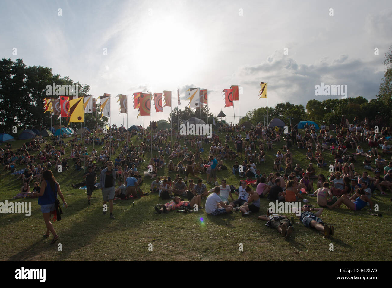 Budapest. 16th Aug, 2014. Festival goers rest on the grass during the Sziget (Hungarian for 'Island') Festival on the Obuda Island in Budapest, Hungary on August 16, 2014. The 22nd edition of the Sziget Festival lasts from August 11 to August 17. It is one of the largest music festivals in Europe, attracting nearly 400,000 people every year. Credit:  Attila Volgyi/Xinhua/Alamy Live News Stock Photo