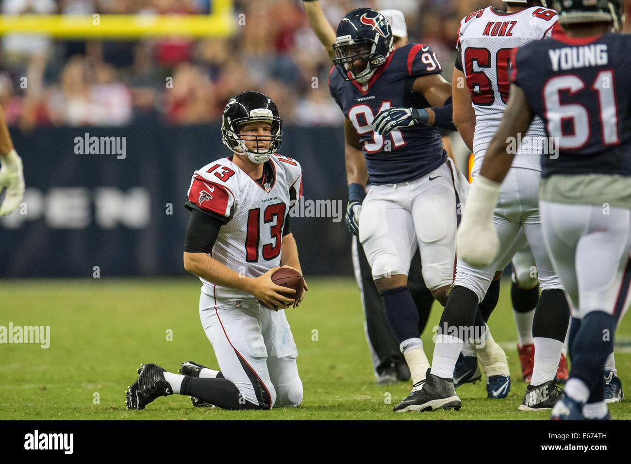 Houston, Texas, USA. 16th Aug, 2014. Atlanta Falcons quarterback T.J. Yates  (13) rises to his knees after being sacked by Houston Texans defensive end  Lawrence Sidbury (91) during the 4th quarter of