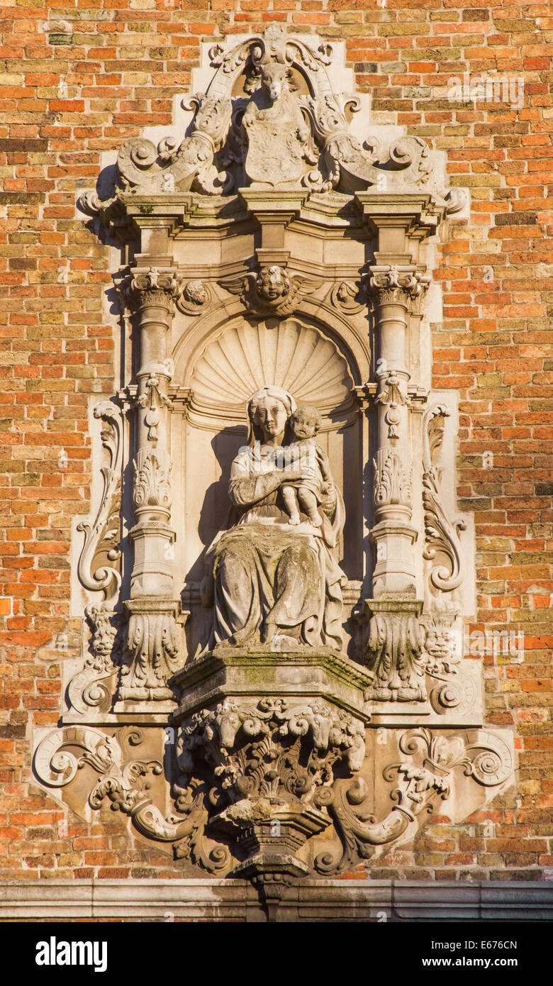 BRUGES, BELGIUM - JUNE 12, 2014: The Baroque statue of Madonna on the facade of Belfort van Brugge. Stock Photo