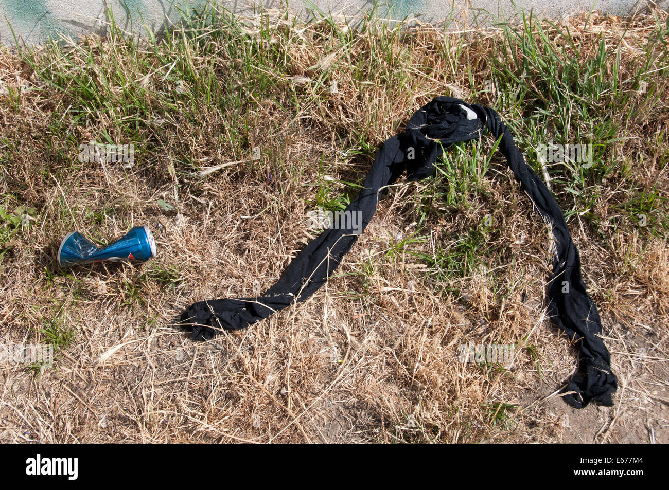 The next morning - Abandoned tights and beer can beside the canal Stock  Photo - Alamy