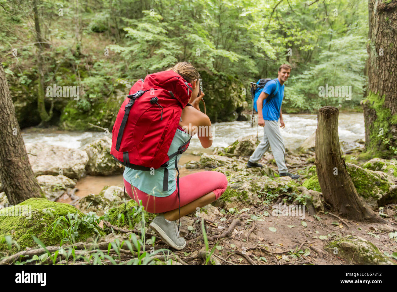 Young woman taking photo of man at hiking Stock Photo
