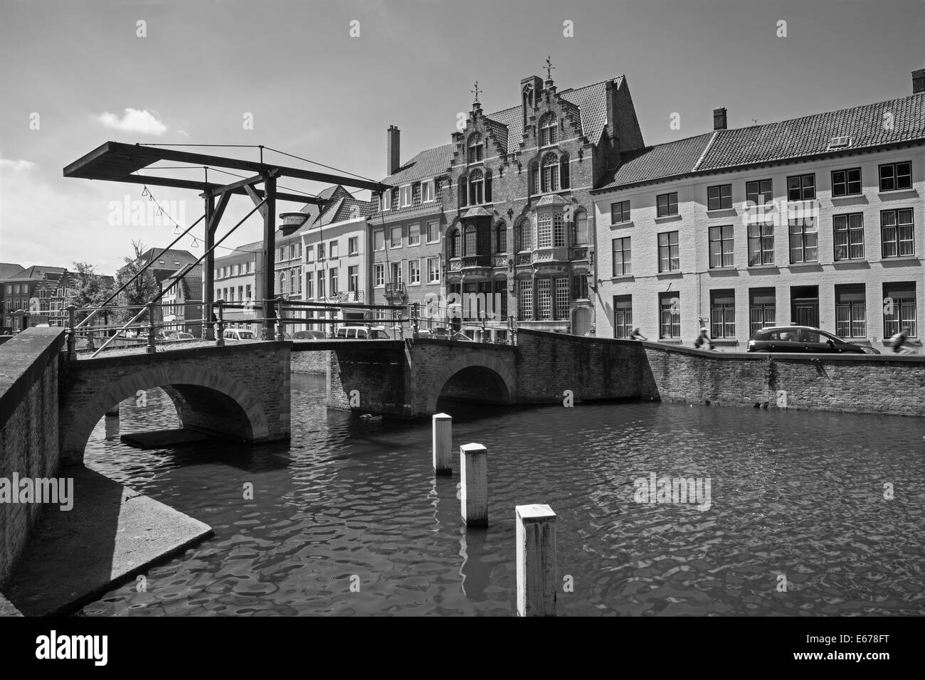 BRUGES, BELGIUM - JUNE 13, 2014: Little bascule bridge and typically house over the canal from Sint Annarei street. Stock Photo