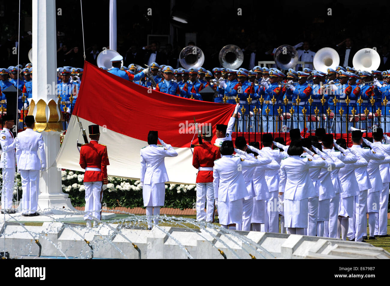 Jakarta, Indonesia. 17th Aug, 2014. Indonesian flag-raising squads salute to the national flag during a celebration of the country's 69th independence anniversary at the presidential palace in Jakarta, Indonesia, Aug. 17, 2014. Credit:  Agung Kuncahya B./Xinhua/Alamy Live News Stock Photo