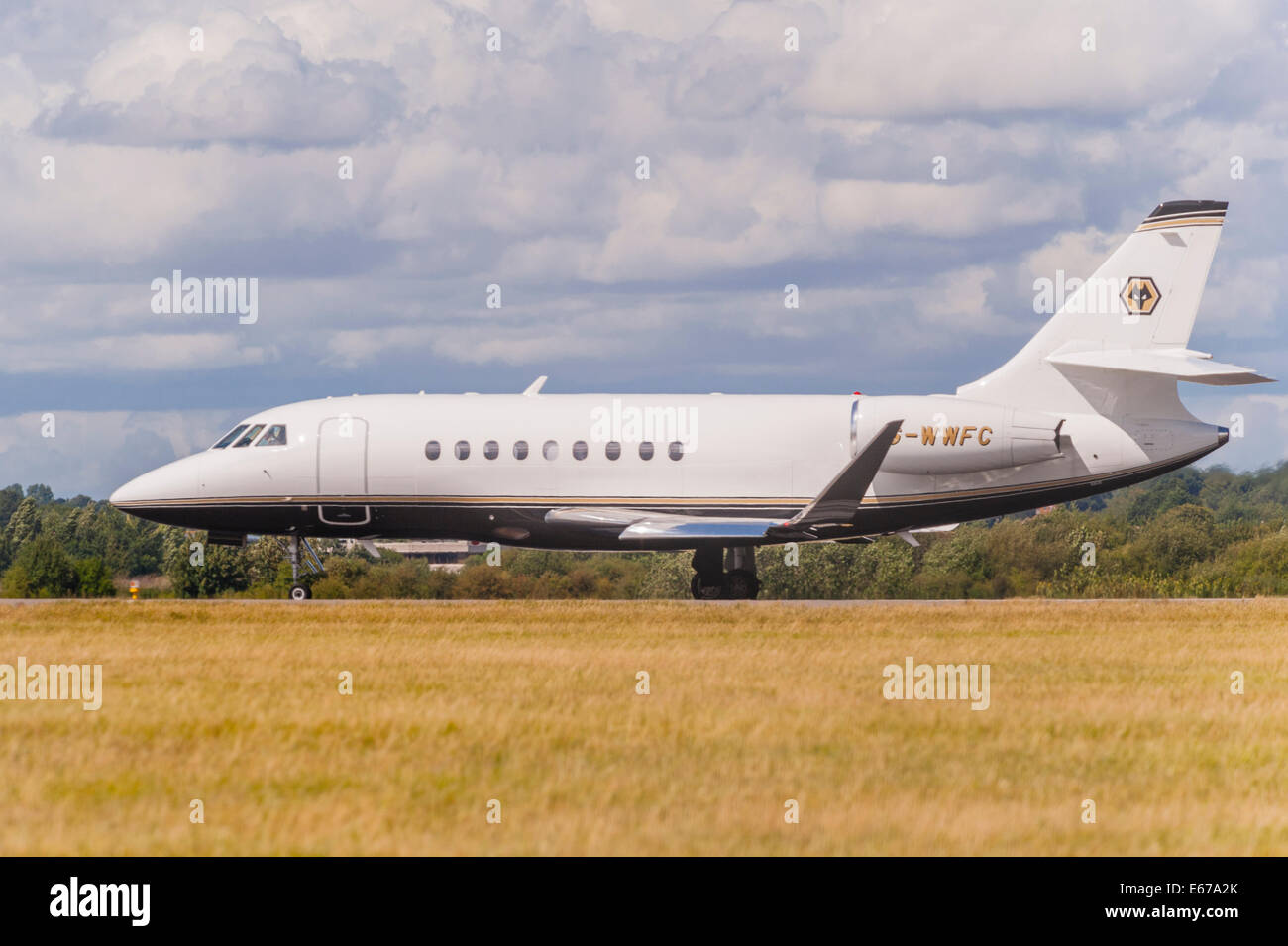 A plane Dassault Falcon 2000EX (G-WWFC) taking off from Luton Airport in England , Britain , Uk Stock Photo