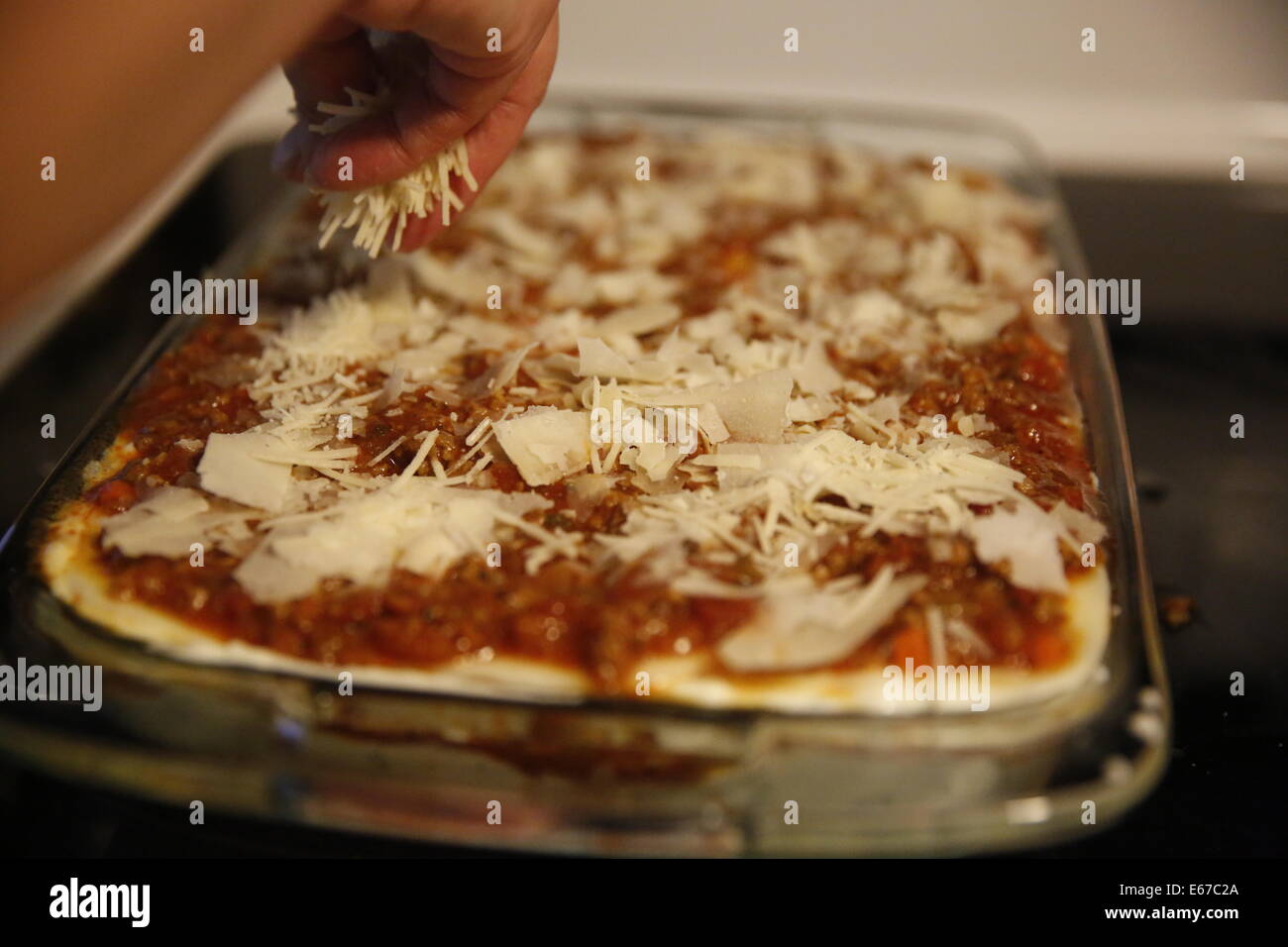 Making Lasagna Italian food cheese layers parmesan ingredients process cooking Stock Photo