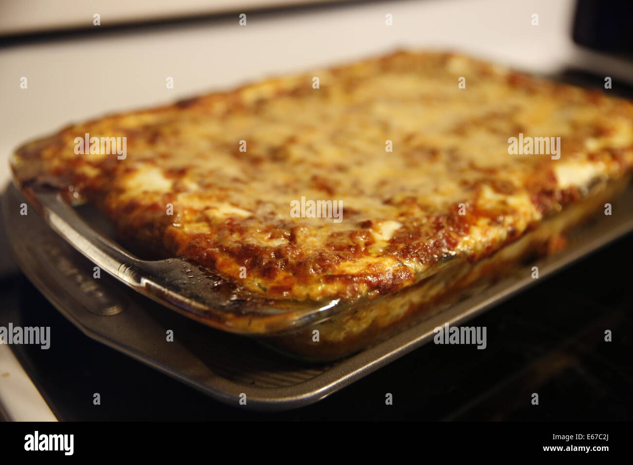 Making Lasagna Italian food cheese layers top ingredients process cooking cooked finished hot sitting cooling down close up cook Stock Photo