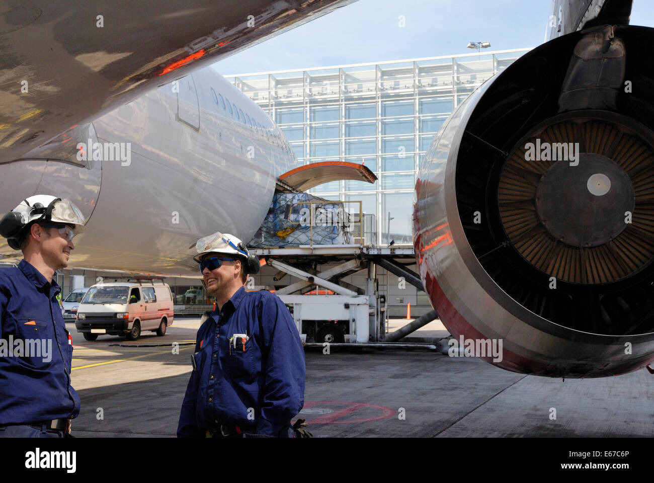 airplane mechanic with large jet engine in the background Stock Photo