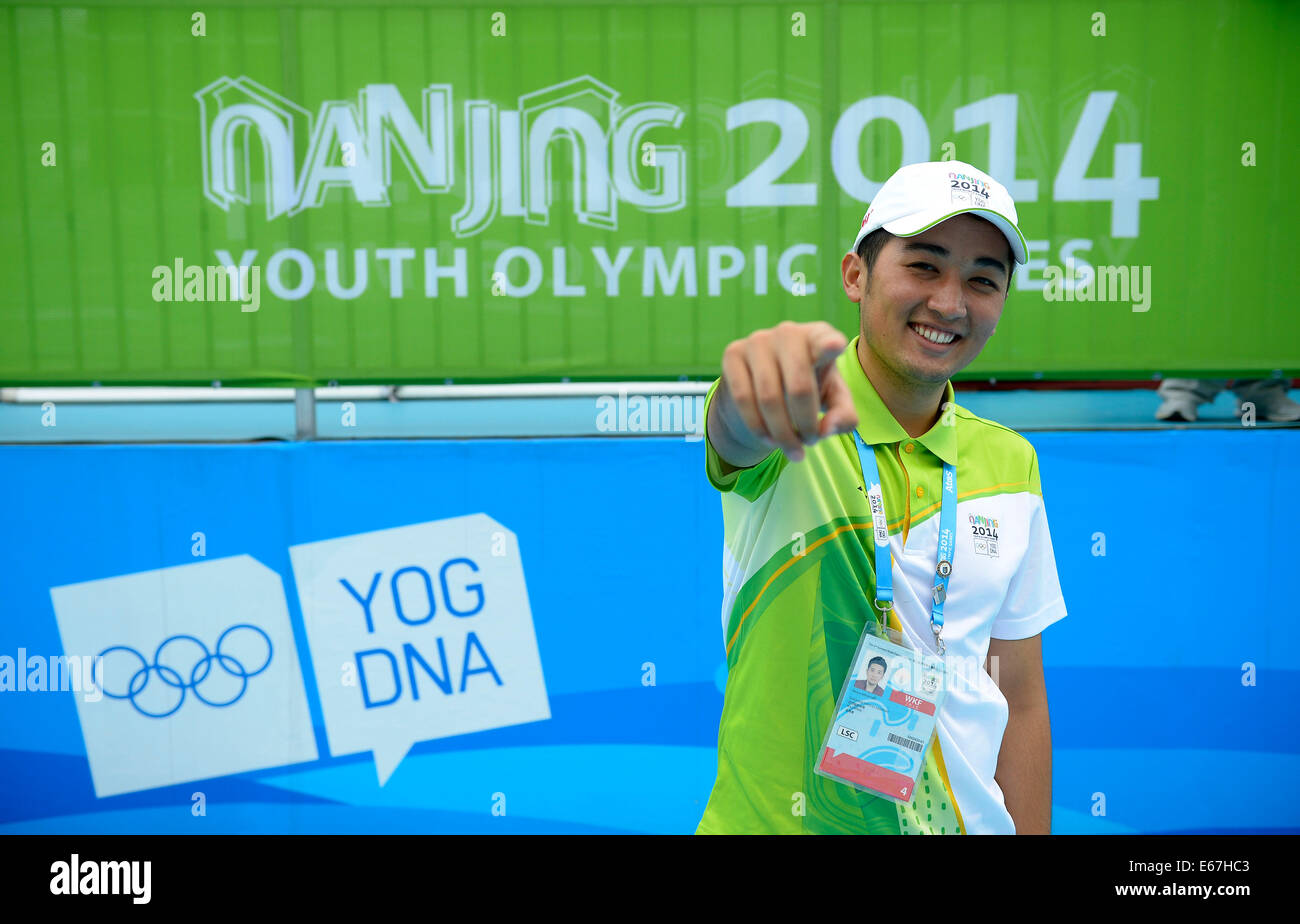 (140817) -- NANJING, Aug. 17, 2014 (Xinhua) -- Medeu Askhatuly poses for a photo out of his office at the cycling venue during Nanjing 2014 Youth Olympic Games on Aug. 17, 2014.       21-year-old Medeu Askhatuly from Kazahkstan works as a volunteer of language service for cycling event during the Nanjing 2014 Youth Olympic Games. He is a senior student majoring in International Economics and Trade in Nanjing University of Information Science and Technology and is fluent in Kazakh, Russian, English and Chinese. He came to China with his father when he was a child and became fascinated by Chines Stock Photo