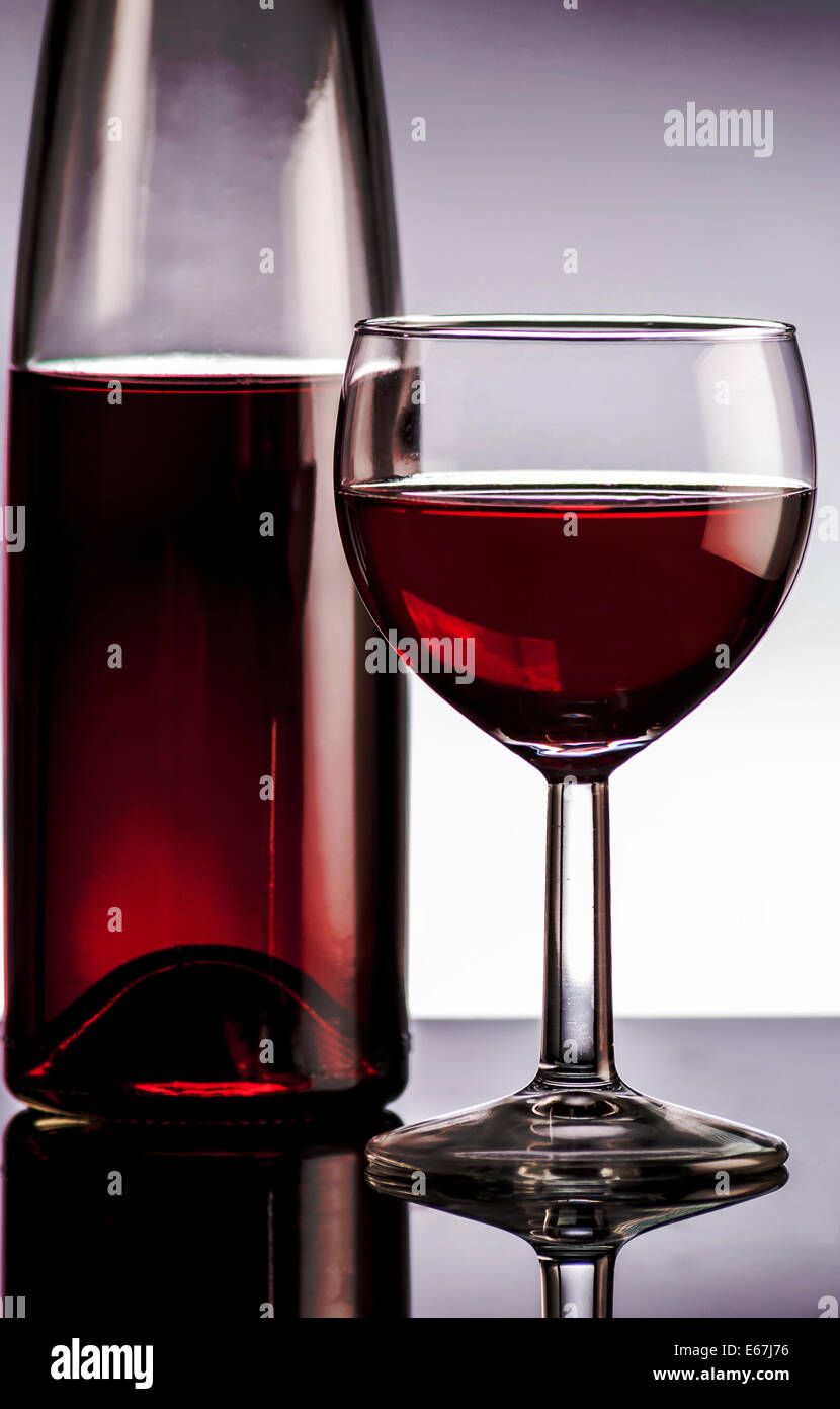 Red wine in bottle on black reflect background Stock Photo - Alamy