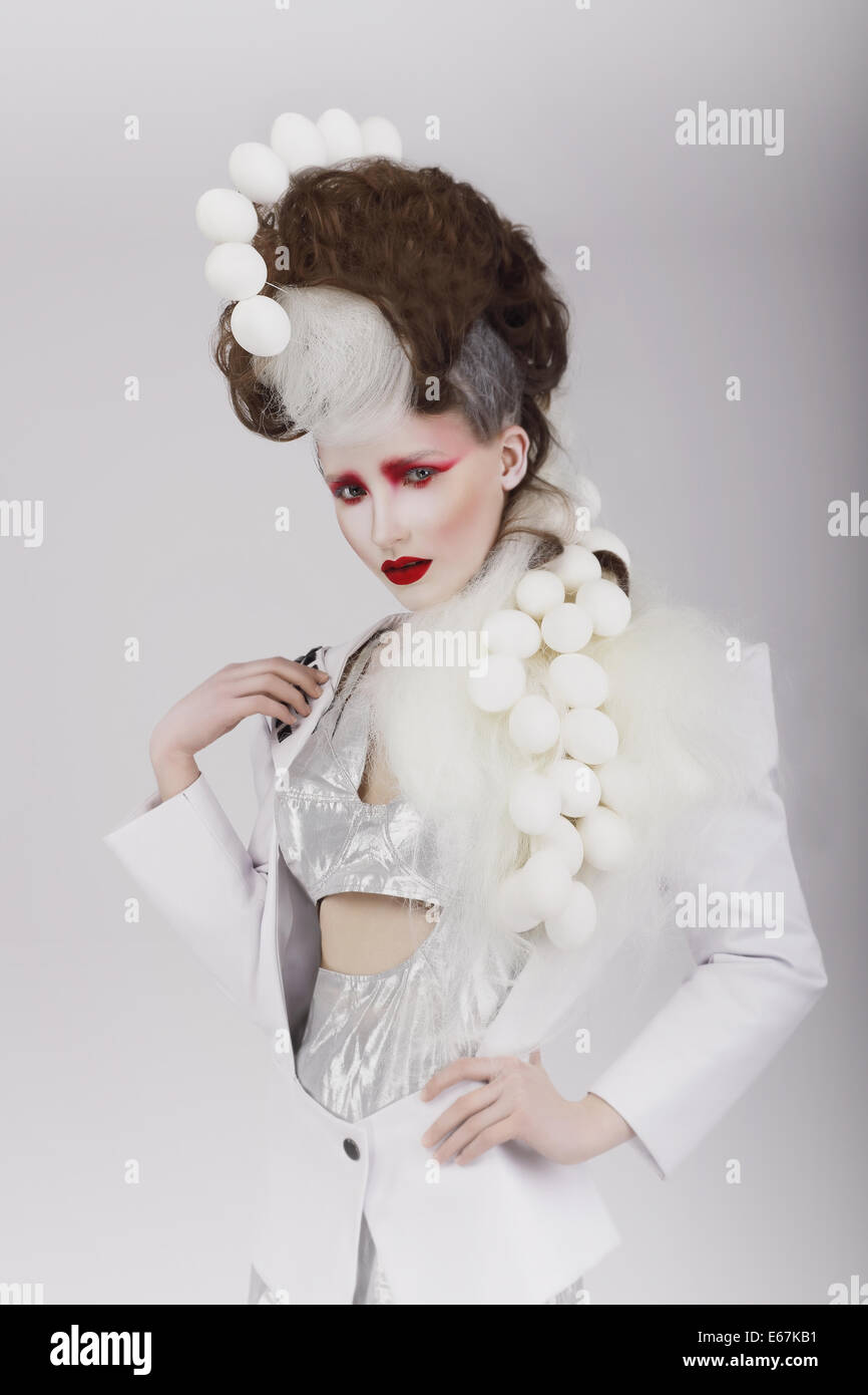 Haute Couture. Extravagant Woman in Cyber Costume and Theatrical Hair-do Stock Photo