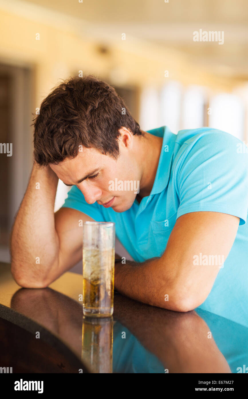 sad and lonely young man sitting at the bar Stock Photo Alamy