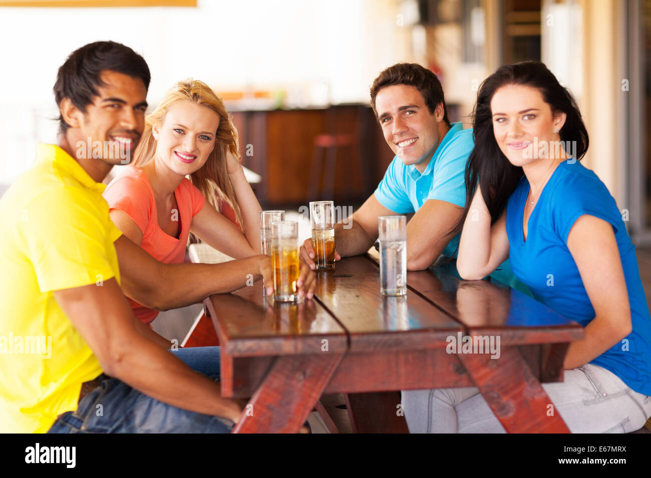 group of friends hanging out at bar Stock Photo - Alamy