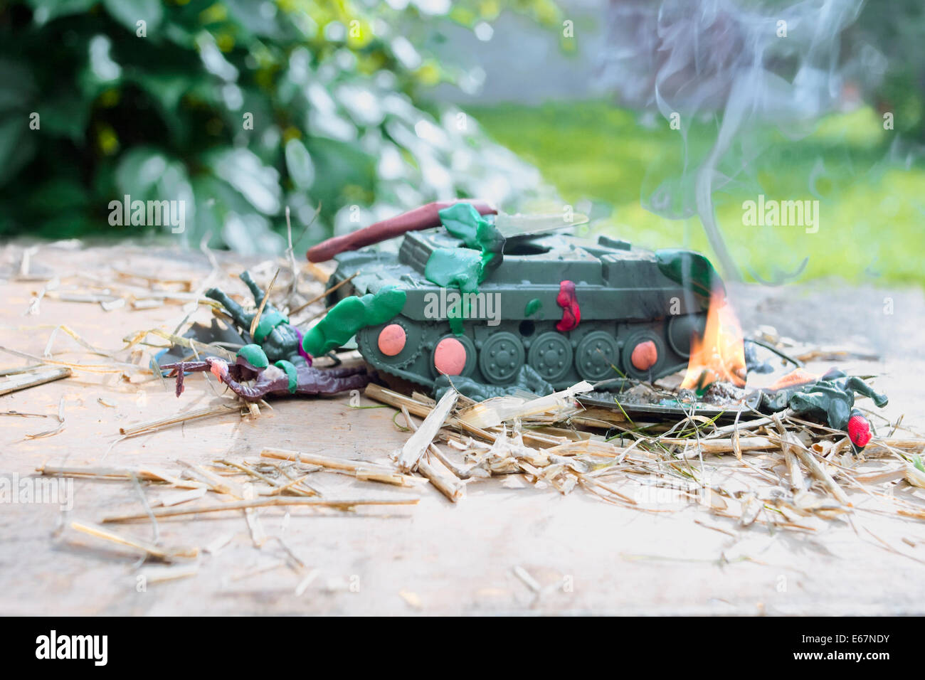 Destroyed toy tank and injured soldiers Stock Photo