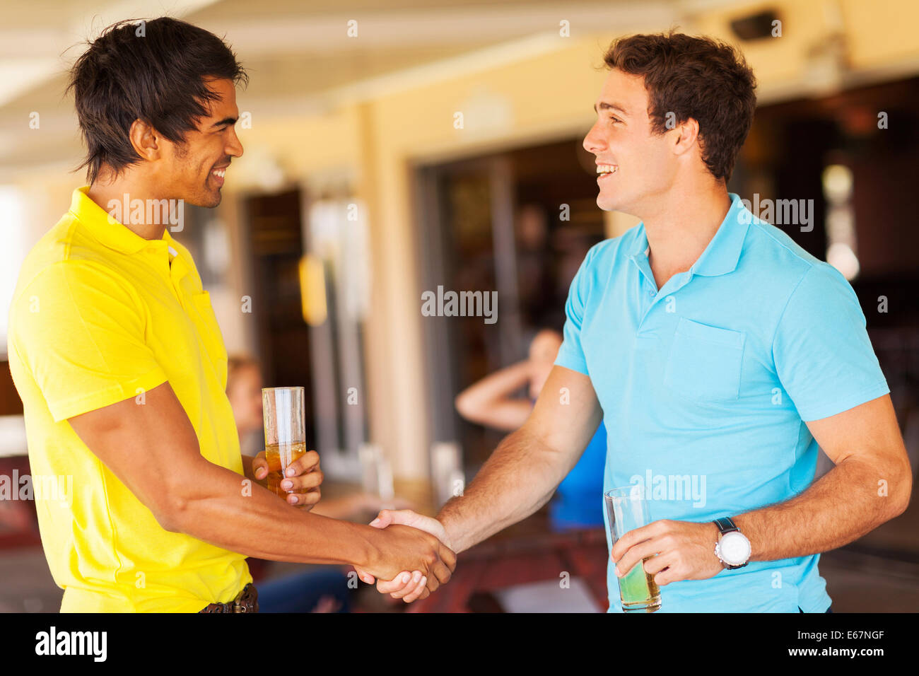 happy friends handshaking at the party Stock Photo