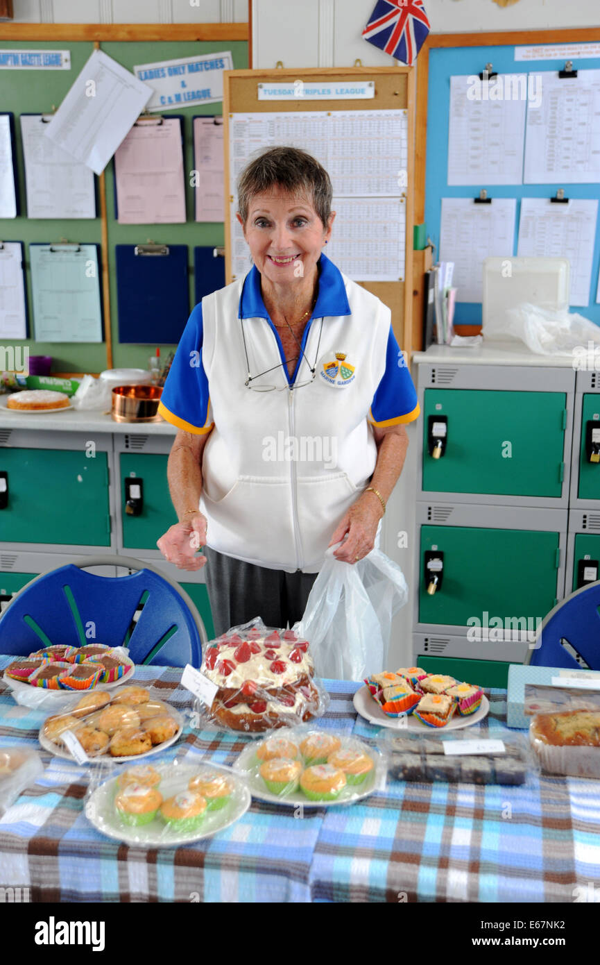 Elderly woman at the cake stall at The Marine Gardens Bowls Club in
