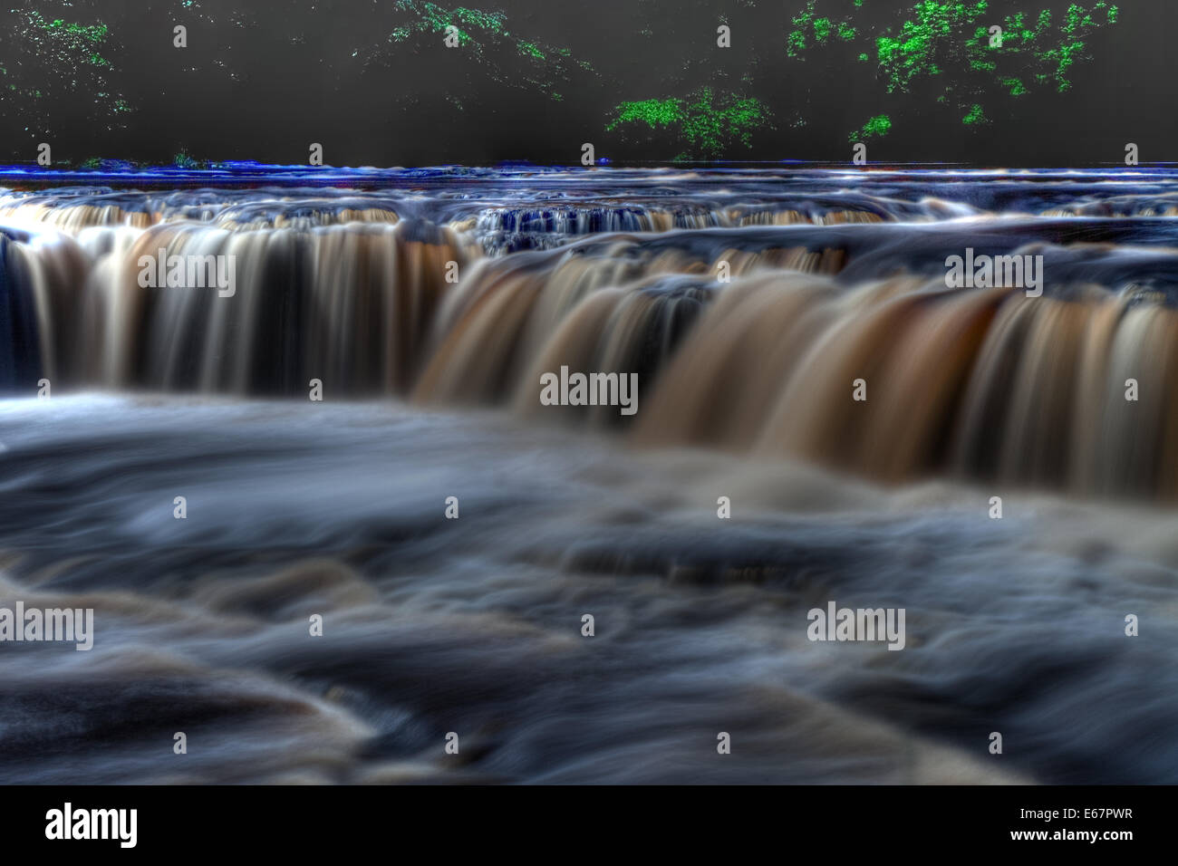 The many colours of the fast flowing Aysgarth Falls. Stock Photo