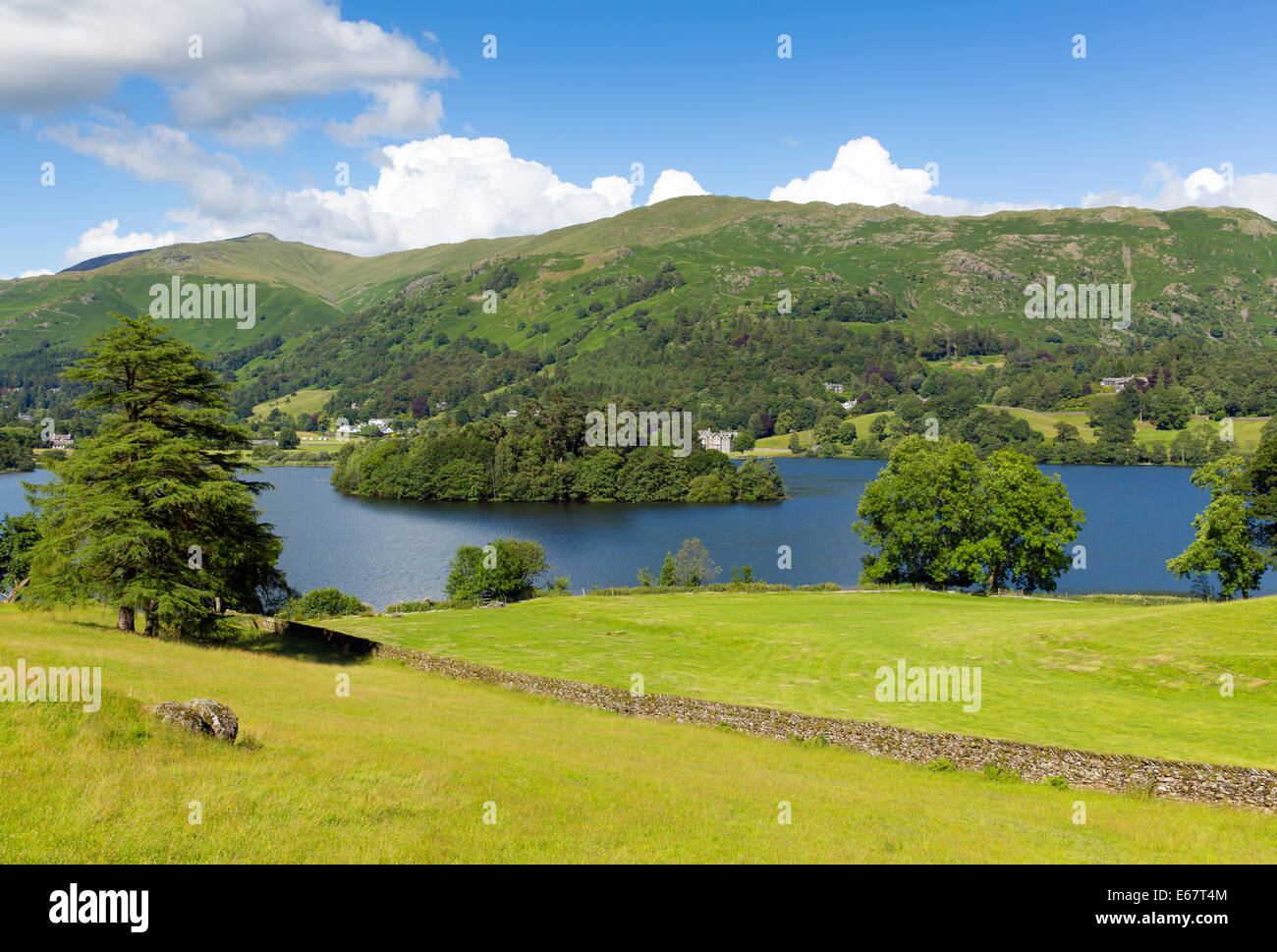 Grasmere Lake District Cumbria England UK with blue sky mountains and white clouds on a beautiful summer day in this National Pa Stock Photo