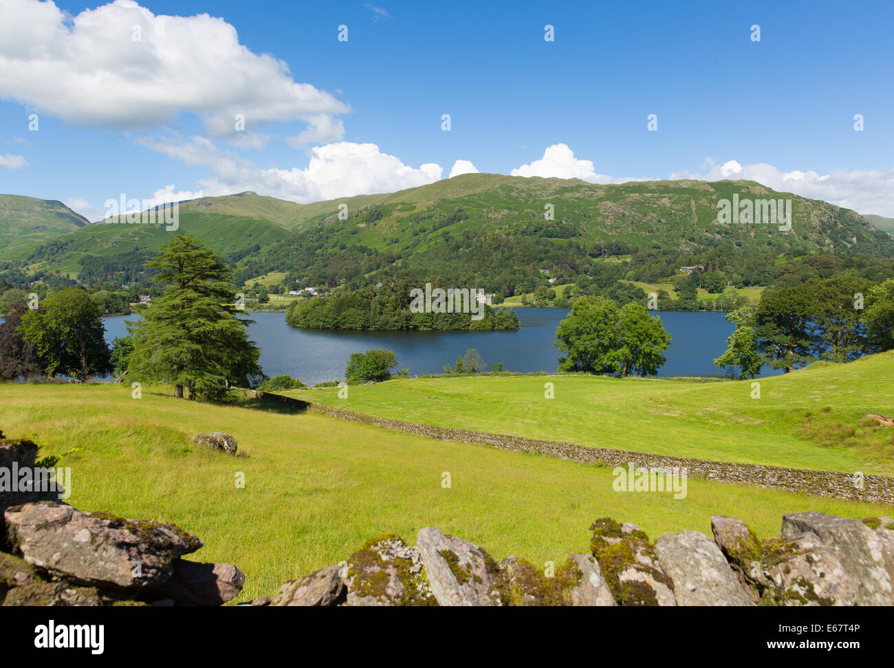 Grasmere the Lake District Cumbria England UK with blue sky mountains and white clouds on a beautiful summer day in this National Pa Stock Photo