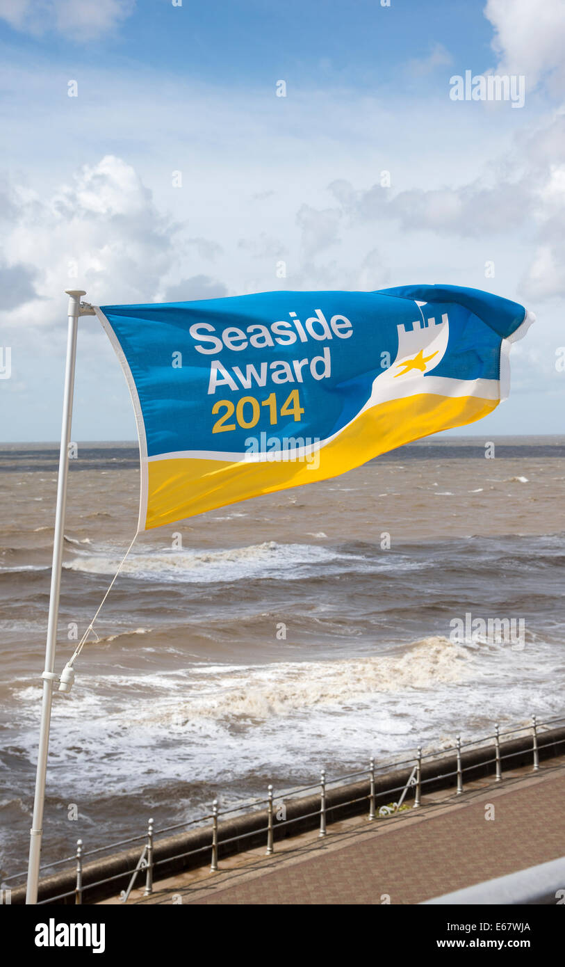 Seaside Award flag flying over coastline at Blackpool Lancashire England UK A brisk wind blowing across the sea in summer Stock Photo