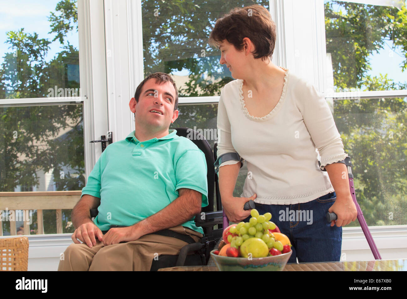 Couple with Cerebral Palsy sitting on their deck Stock Photo