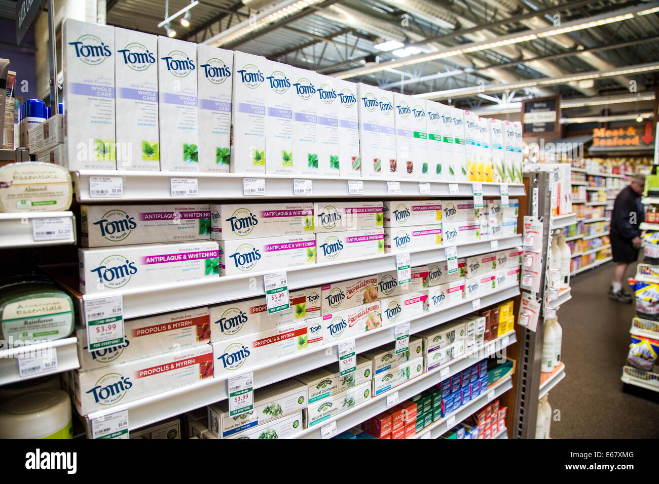 Tom's of Maine toothpaste display on shelves in a natural foods grocery store. Stock Photo