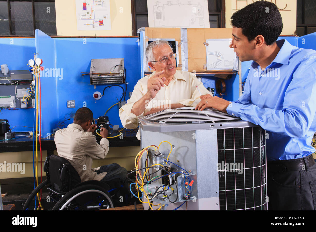Instructor training to students about air conditioning units in HVAC
