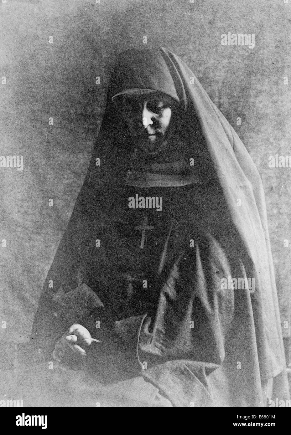 Nun with hands folded, praying, seated, circa 1895 Stock Photo