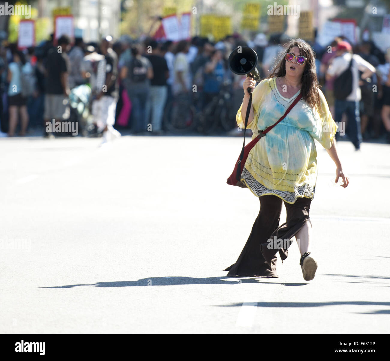 Los Angeles, California, USA. 17th Aug, 2014. A protest leader makes her way down Main Street carrying a megaphone in the Los Angeles downtown on Sunday afternoon.----About 800 protesters gathered in front of the Los Angeles Police Department in the downtown on Sunday afternoon to protest the officer involved shooting of a Ezell Ford in South Central Los Angeles last week as well as to show support the residents of Ferguson, Missouri, in their protests against the police there. The assembled crowd displayed placards and signs with slogans against the police, joining together to chant their s Stock Photo