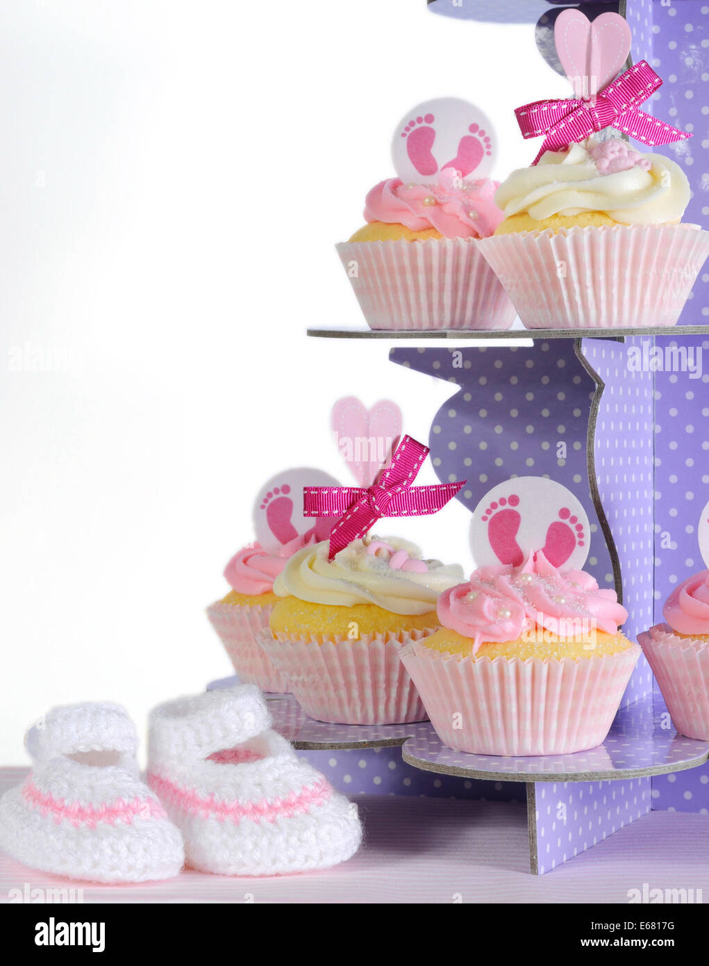 Pink theme baby girl cupcakes and booties on purple polka dot cupcake