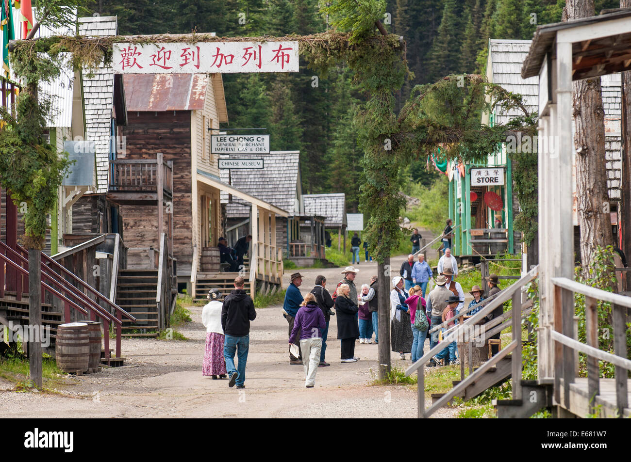 People tourists on main street historic log cabin wooden buildings old gold rush town Barkerville, British Columbia, Canada. Stock Photo