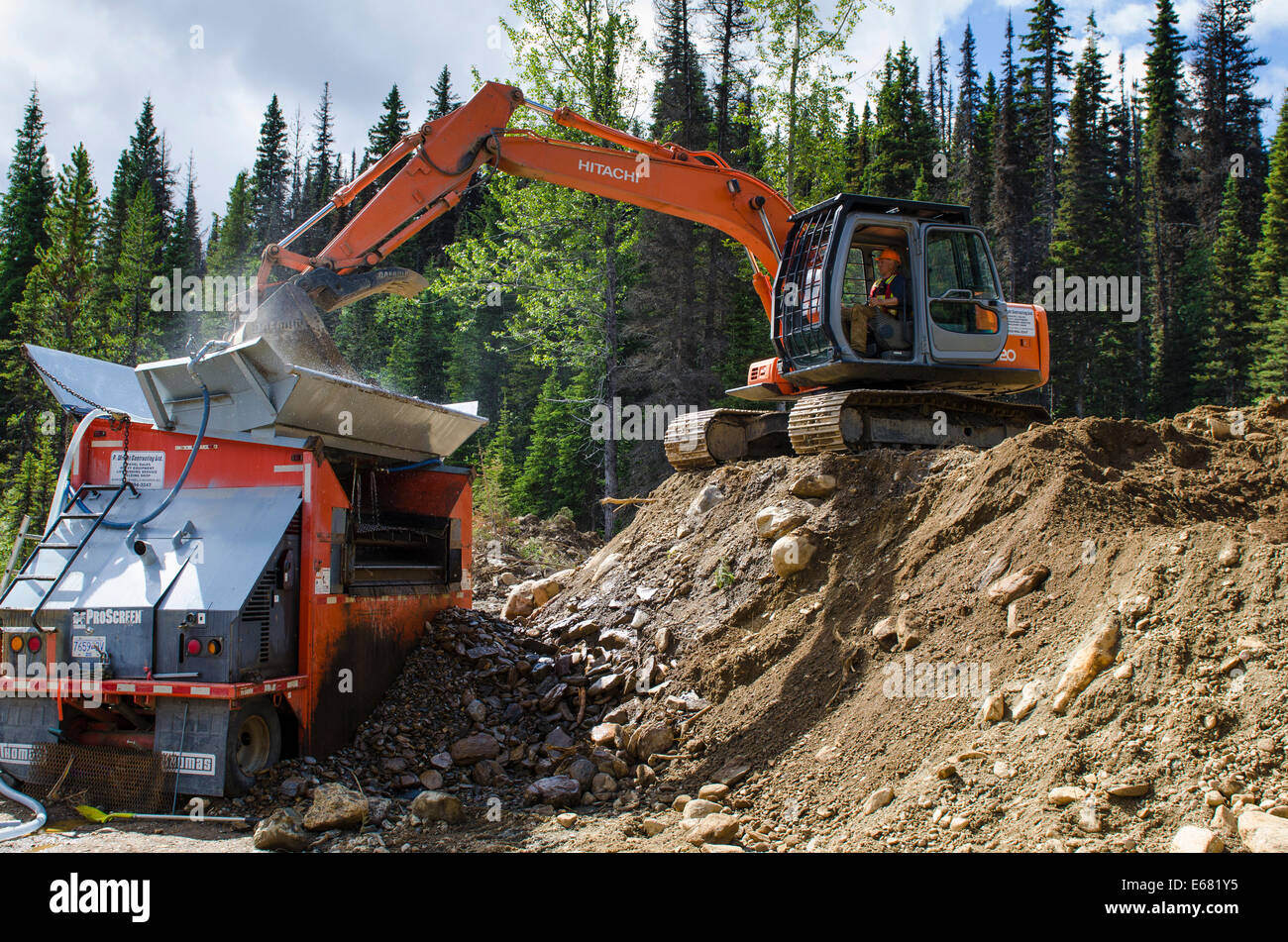 Modern day gold mining mine sluice and excavator heavy machinery equipment in Wells, Barkerville, British Columbia, Canada. Stock Photo