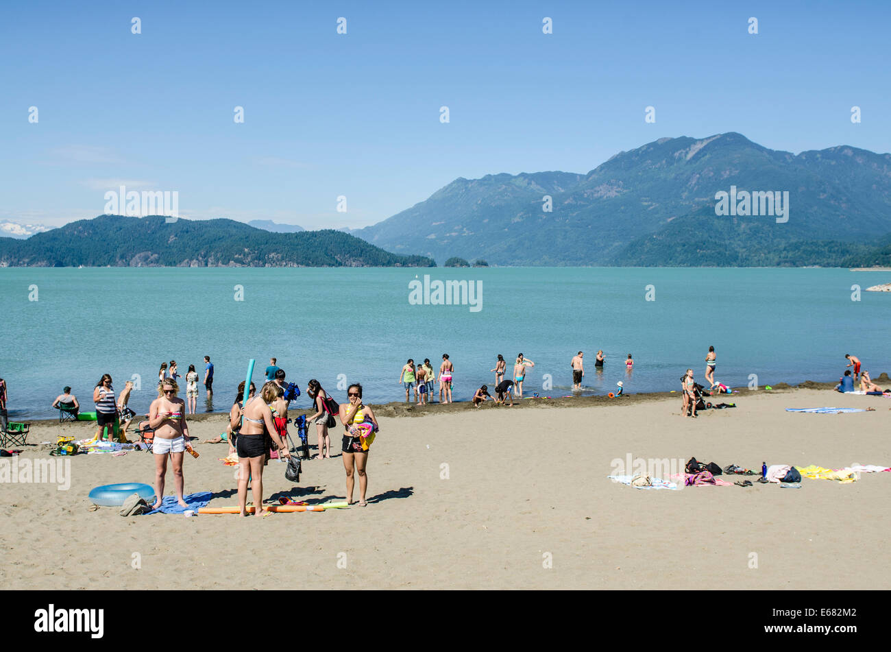 Vacationers people family on beach at Harrison Lake, Harrison Hot Springs resort, British Columbia, Canada. Stock Photo