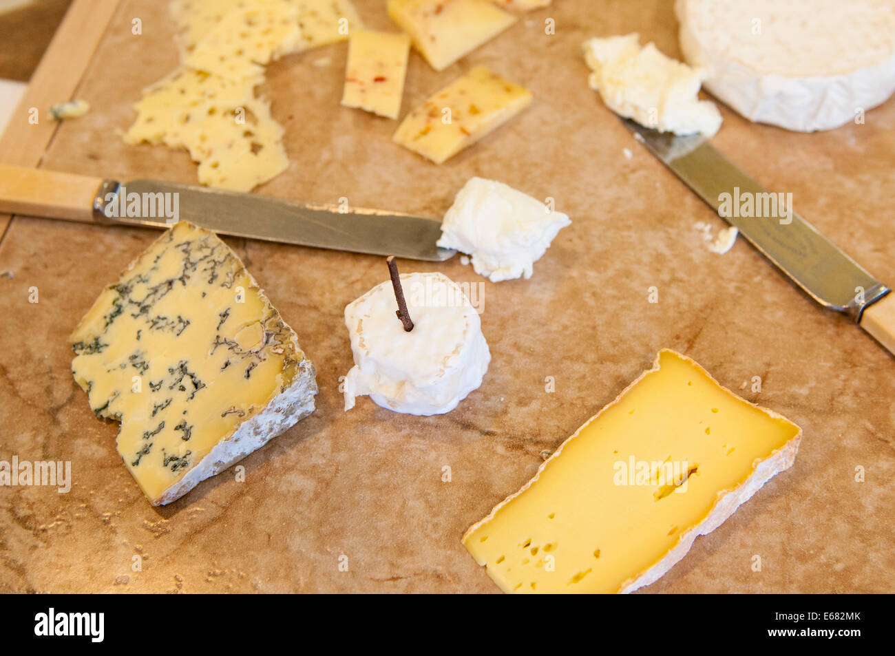 Homemade cheeses cheese knives on cutting board at Farm House Natural