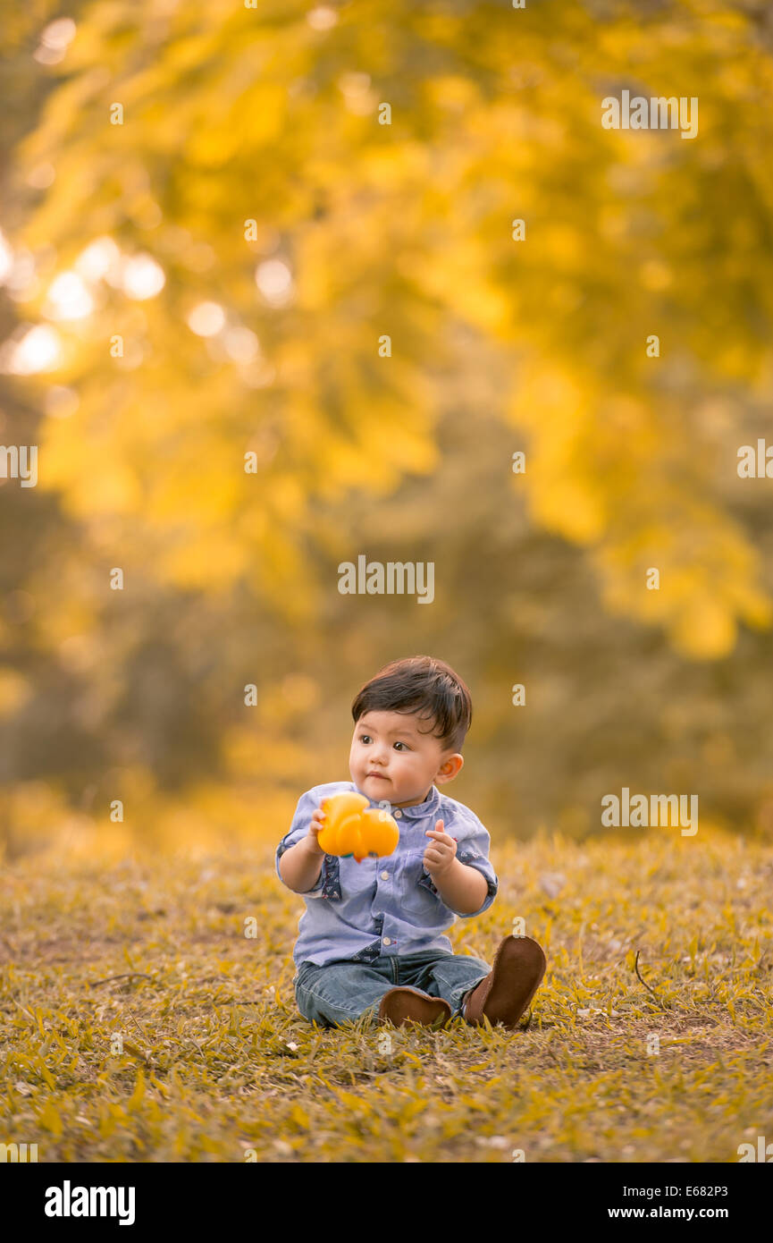 Young 10month old Asian boy in a park Stock Photo Alamy