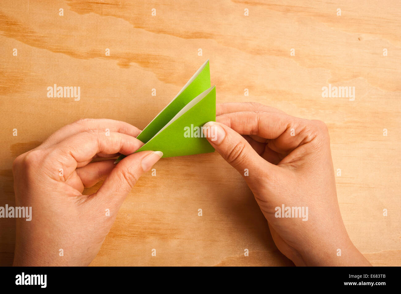 woman folding paper for origami Stock Photo