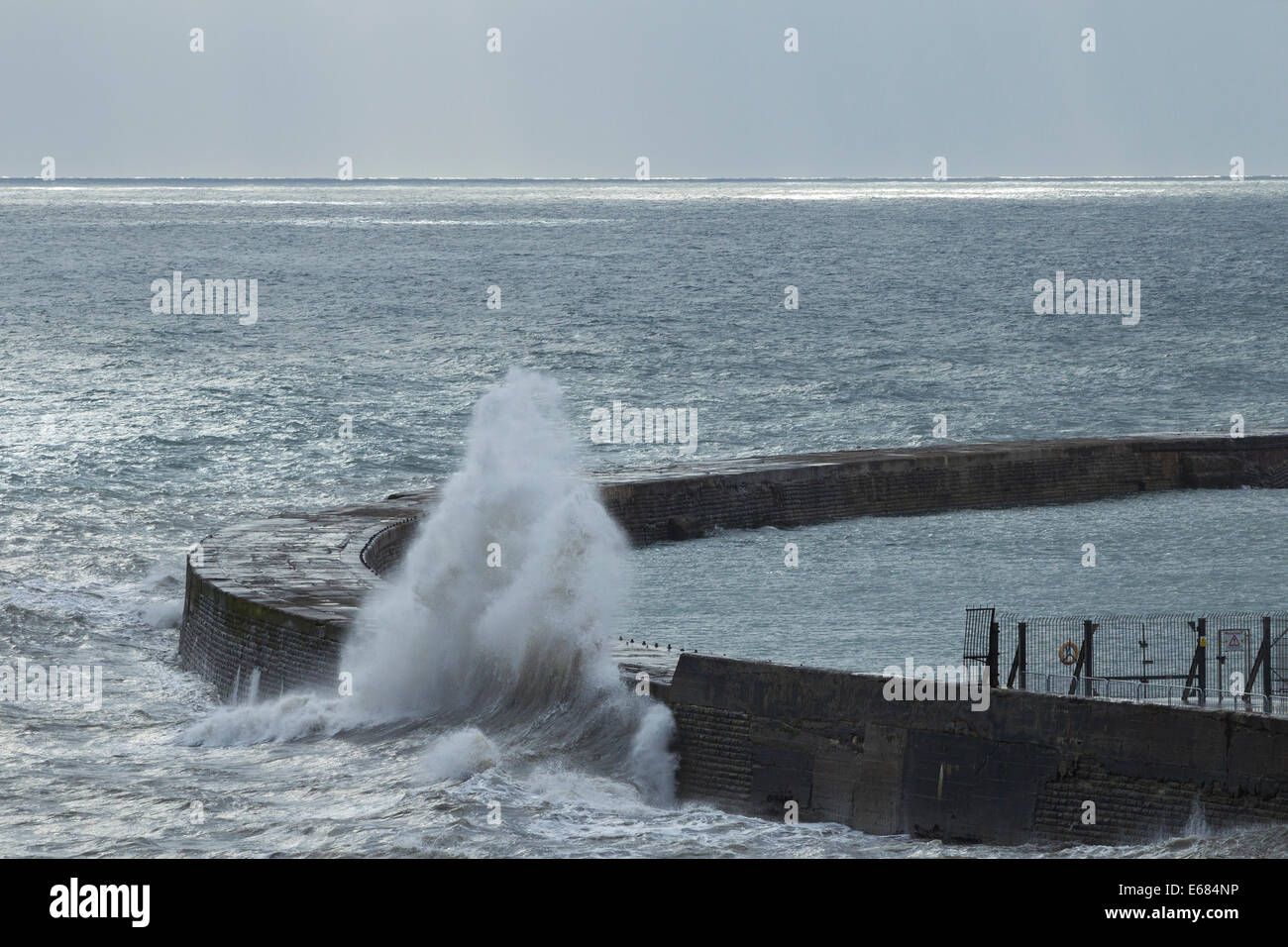 Seaham, County Durham, UK. 18th Aug, 2014. UK. Weather: waves crashing over harbour wall at Seaham on the north east coast as gale force northerly winds blow down the east coast Credit:  ALANDAWSONPHOTOGRAPHY/Alamy Live News Stock Photo