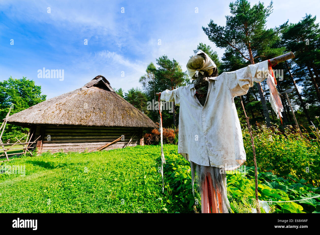 Scarecrow and traditional hut Stock Photo - Alamy