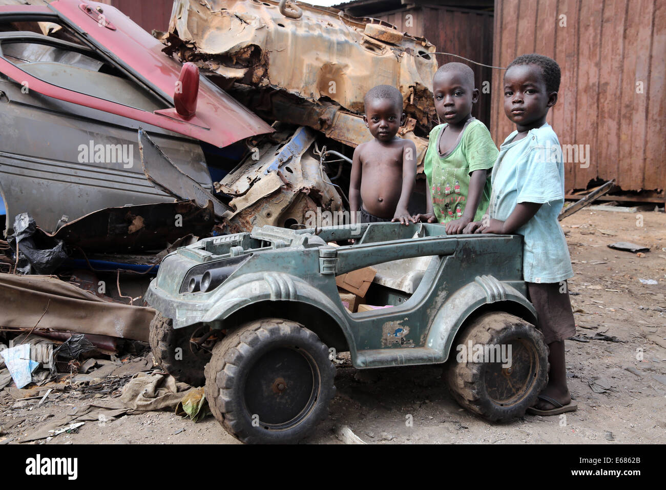 Children playing with broken toy cart on the Agbogbloshie garbage dump