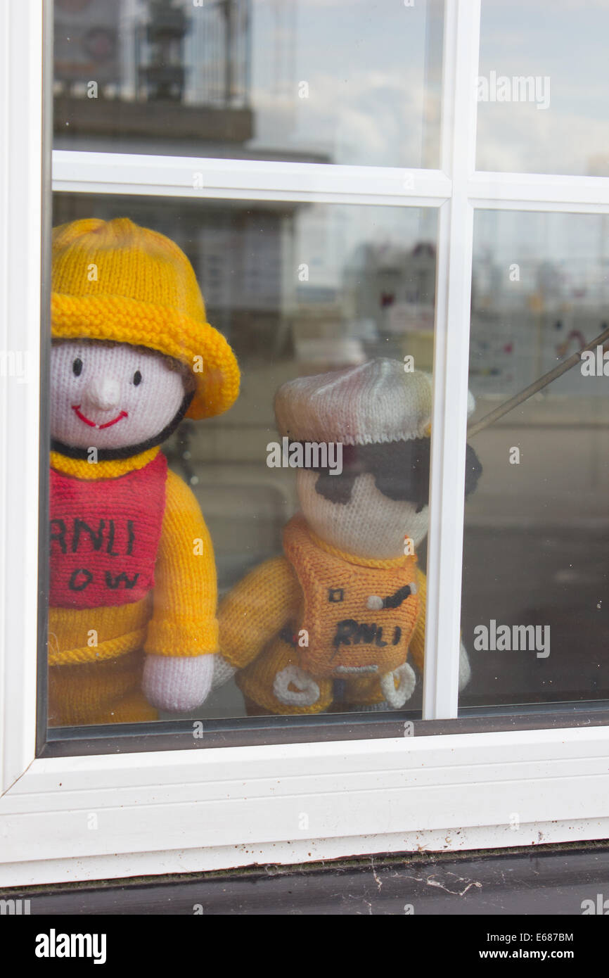 RNLI knitted woollen crew characters in a shop window Yarmouth Isle of Wight UK Stock Photo