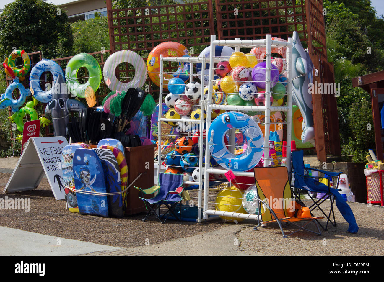 Beachside shop selling balls toys folding chairs flags games fishing