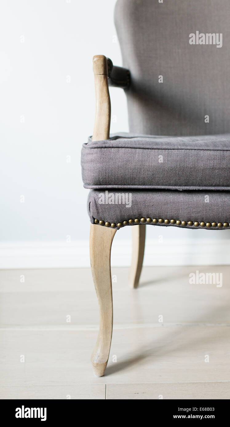 Close up of empty grey chair in home setting Stock Photo