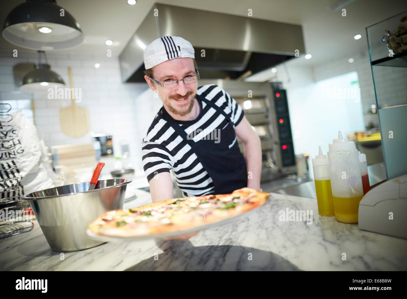 Pizza Express restaurant on king Street in Manchester UK Head Chef making the first pizza Stock Photo